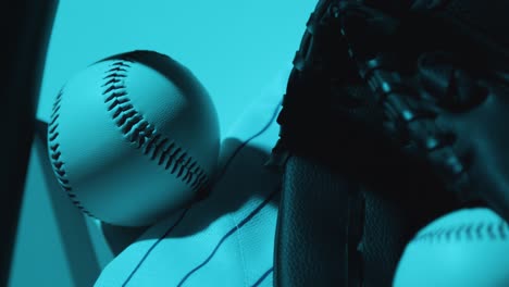 Close-Up-Studio-Baseball-Still-Life-With-Ball-Catchers-Mitt-And-Team-Jersey-With-Blue-Lighting-1